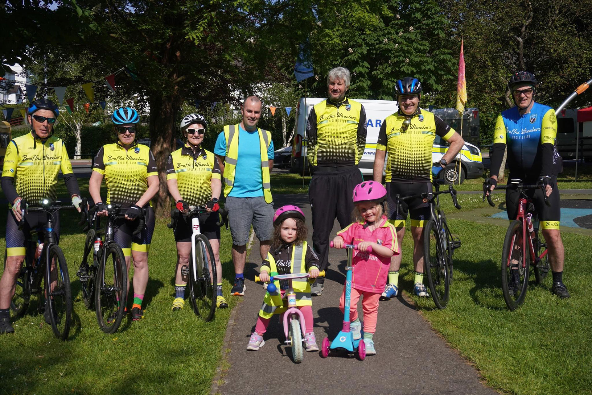 Group of people facing camera while on bikes.