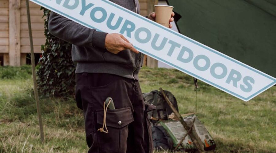Man holds #FindYourOutdoors sign